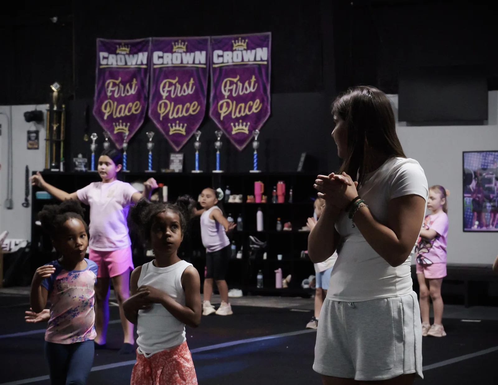 A Category 5 coach guiding young athletes through practice