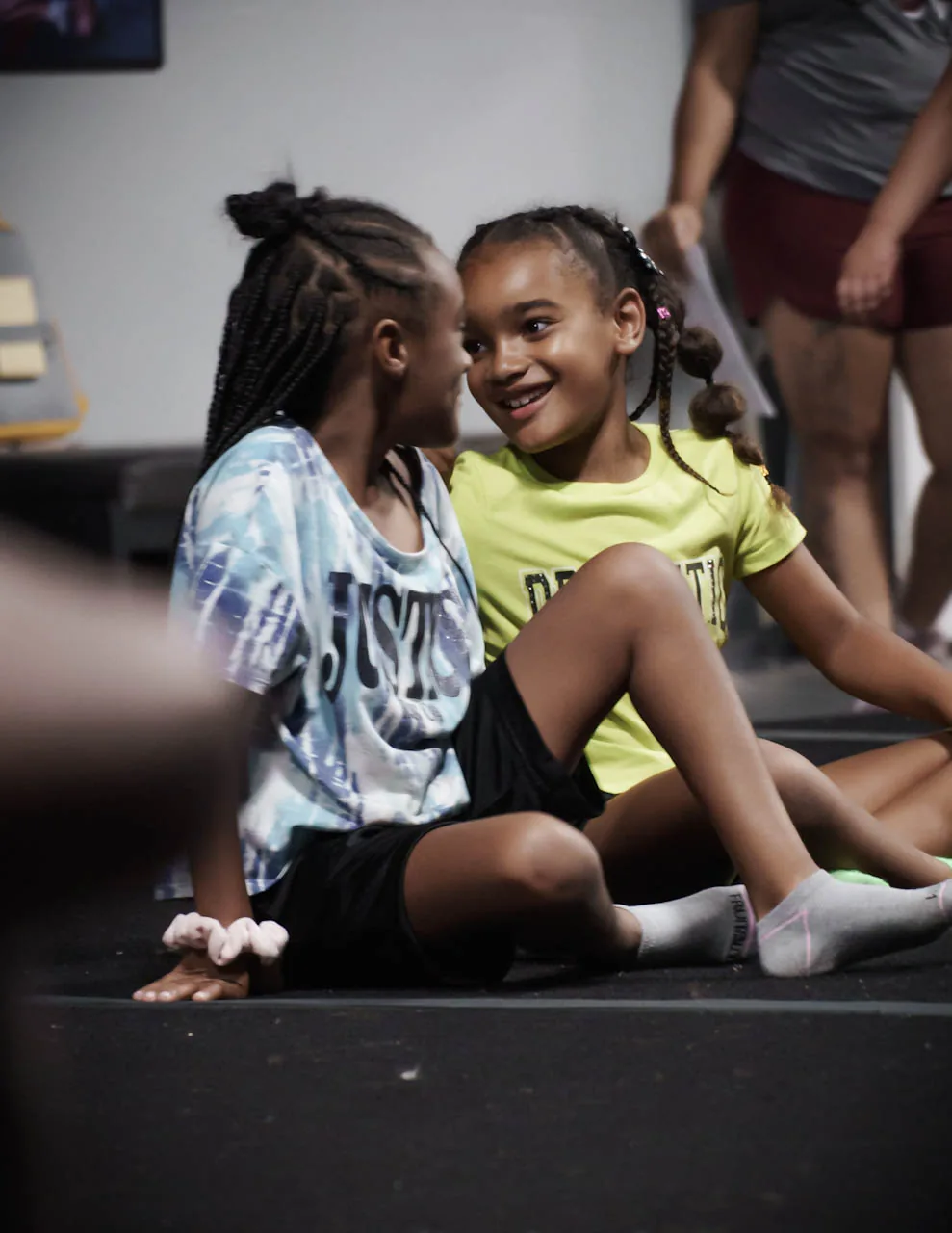 Two young Category 5 athletes sharing a happy moment at camp